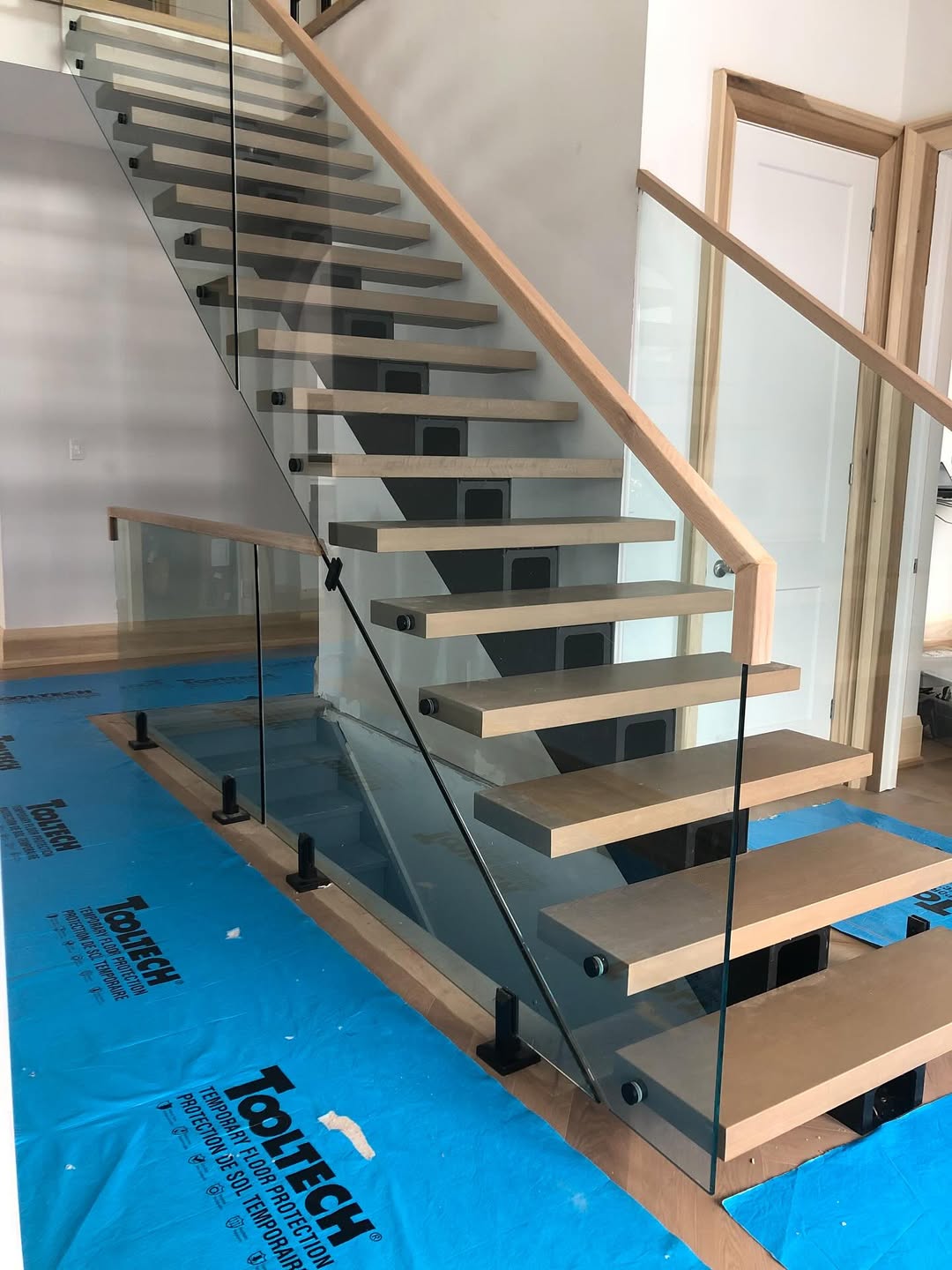 Custom architectural glass balustrade and metal stair fabrication