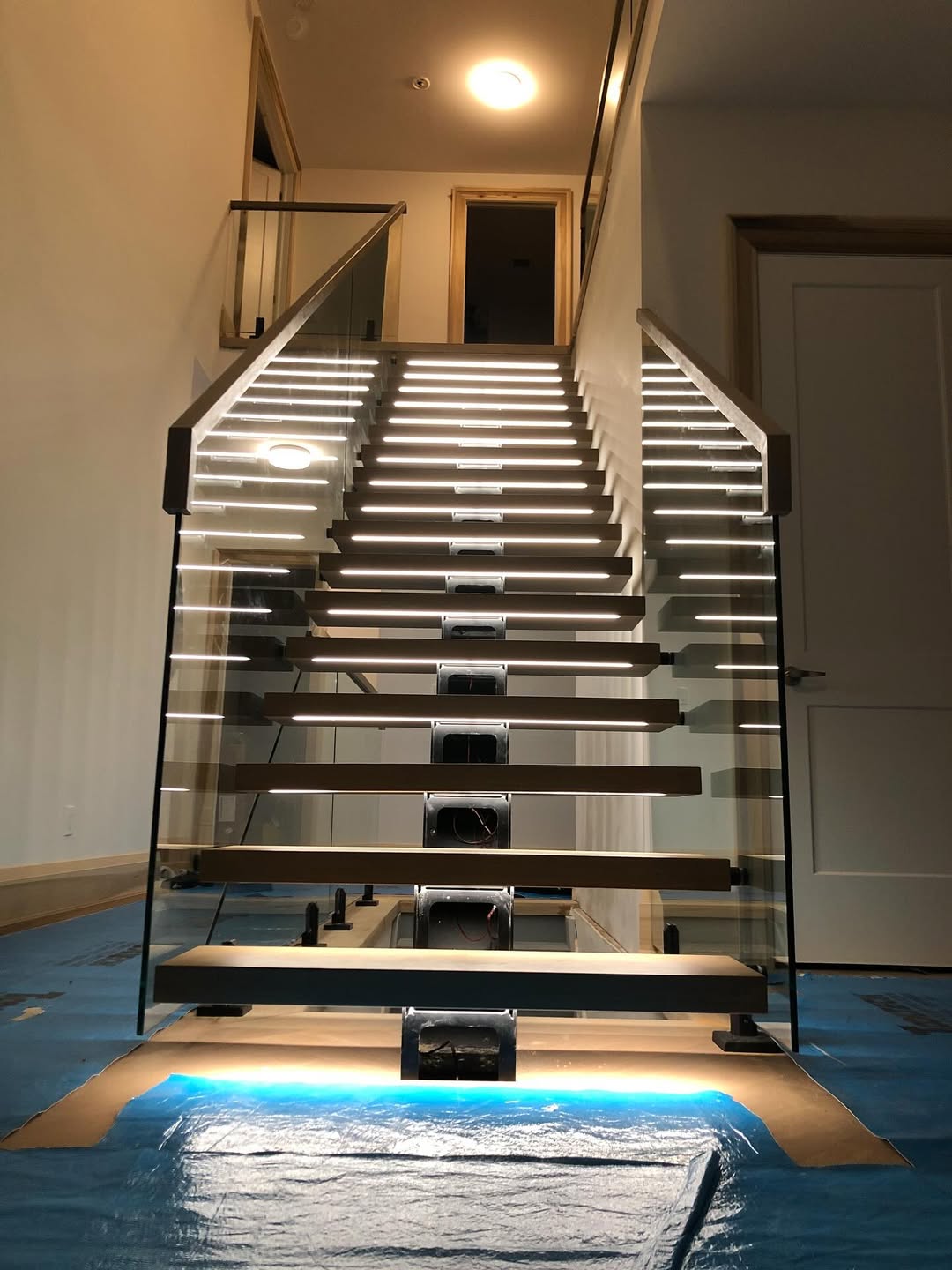 Interior luxury glass staircase railing system engineered for commercial lobbies
